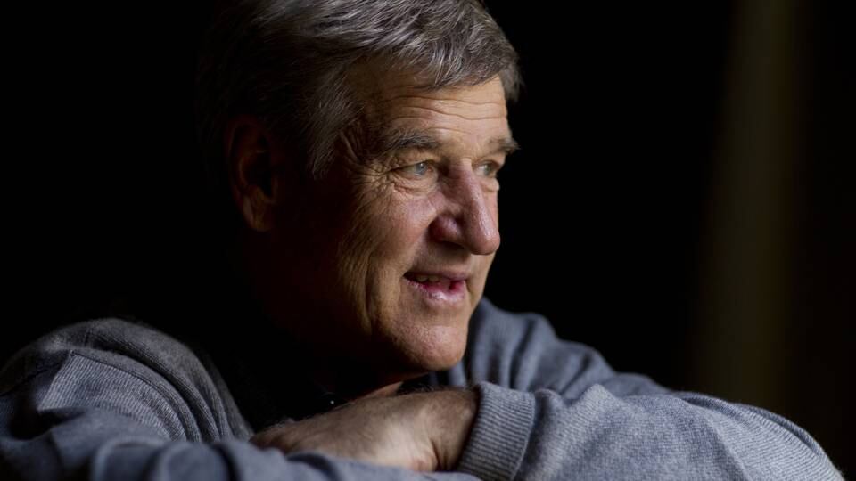 Bobby Orr wearing a Boston Bruins uniform, poised with stick on ice before a game