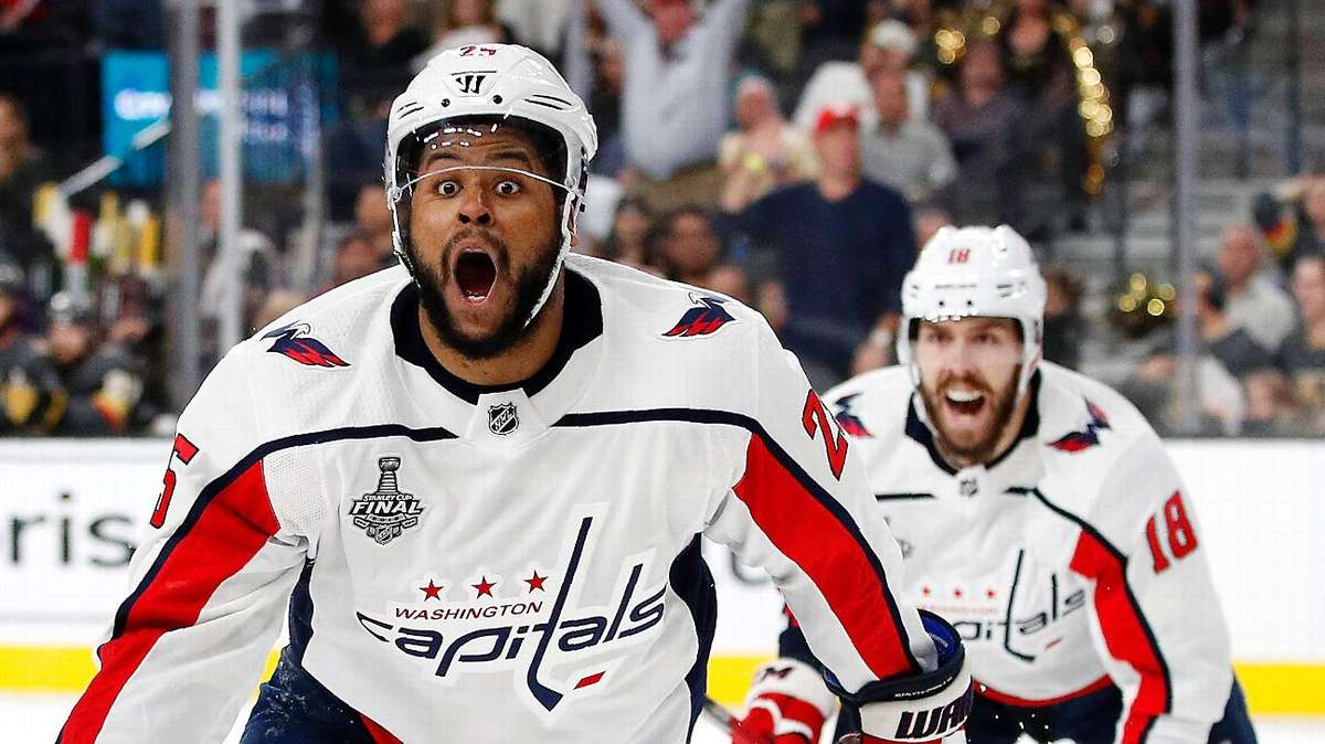 Washington Capitals players crowded together celebrating in the locker room after winning the Stanley Cup