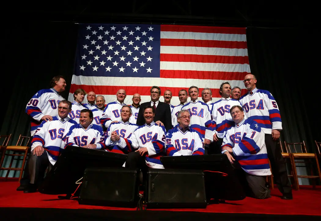 Herb Brooks giving tactical instructions to players on the bench during a 1980 Olympic practice