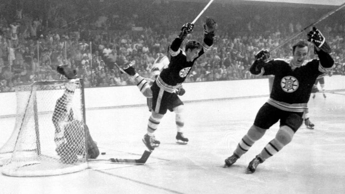 Bobby Orr leading a fast break across the neutral zone with opposing players trailing