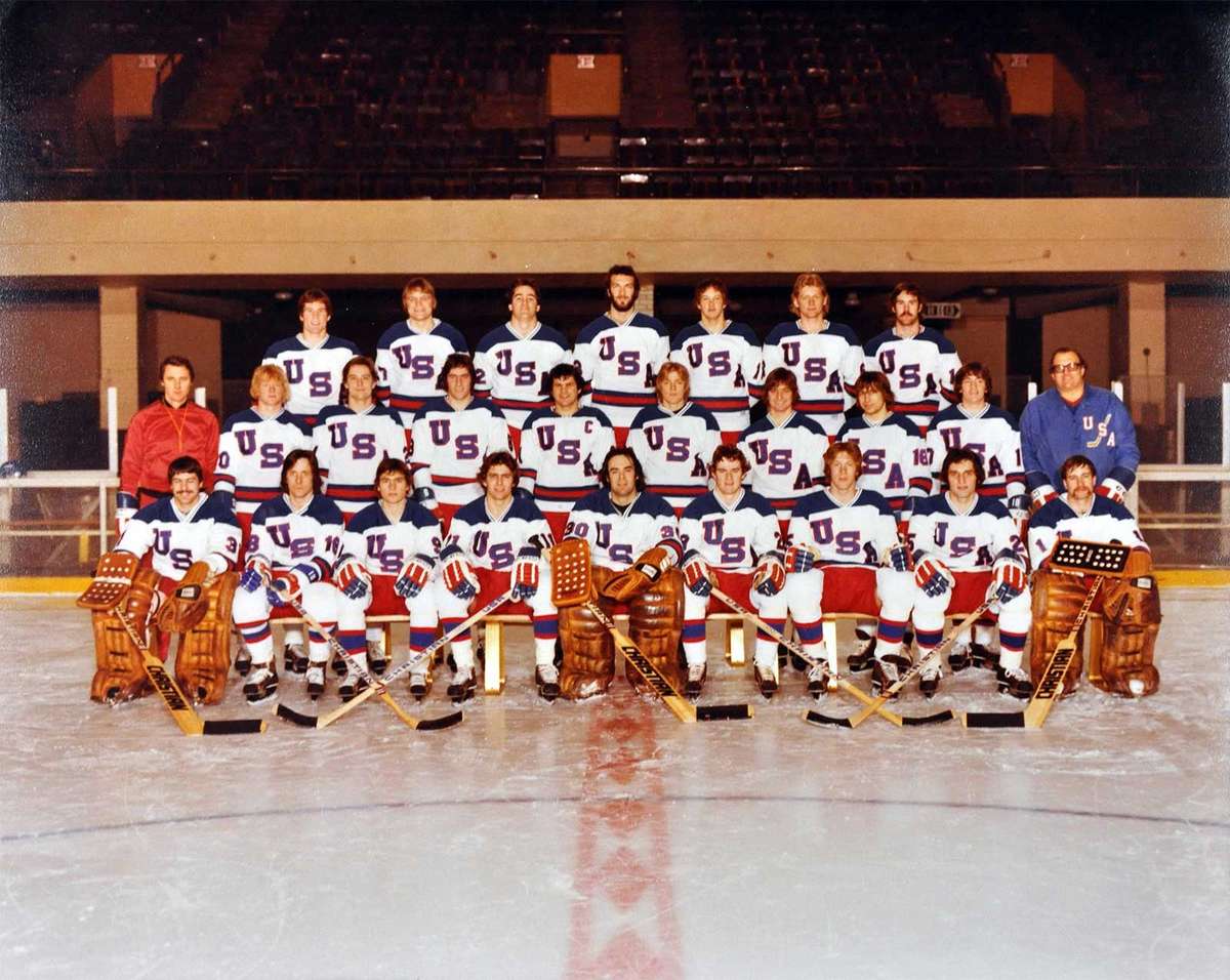 1980 U.S. Olympic hockey team in a tight locker-room huddle before a game