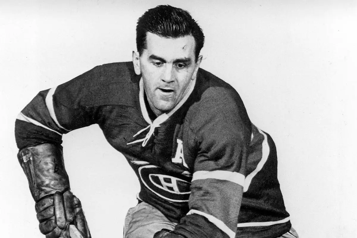 Maurice Richard skating swiftly with the puck during a competitive NHL game