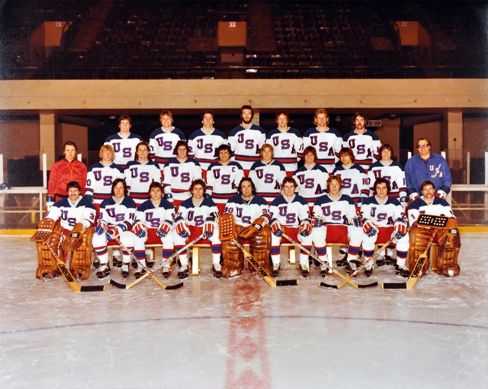 1980 U.S. Olympic hockey team in a tight locker-room huddle before a game